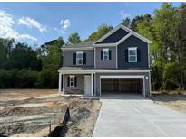 Two-story home featuring an attached two-car garage and classic architectural detailing at 136 Baneberry Pl, Broadway, NC 27505