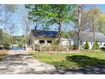 Charming lakeside home featuring a well-maintained lawn and a boat ramp for easy water access at 150 Big Horn Cv, Louisburg, NC 27549