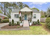 Charming home featuring a covered front porch, landscaped yard, and a tidy, inviting exterior at 2008 Reaves Dr, Raleigh, NC 27608