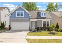 Charming two-story home featuring a two-car garage, manicured lawn, and tasteful landscaping at 356 Avery Glenn Way, Fuquay Varina, NC 27526