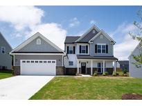 New two-story home with a two-car garage and well-manicured lawn at 40 Rosewood Ln, Youngsville, NC 27596
