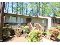 Charming townhouse featuring a cozy porch and mature landscaping at 502 W Poplar Ave # C2, Carrboro, NC 27510