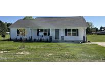 Charming one-story home featuring a well-manicured lawn and inviting front porch at 70 Pate Landing Dr, Selma, NC 27576