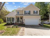 Charming two-story home with green shutters, a two-car garage, and a well-manicured front yard at 703 Midsummer Ln, Apex, NC 27502