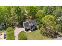 Expansive aerial view of a two-story home with a well-manicured lawn, and a curved driveway at 720 Raymond Dr, Clayton, NC 27527