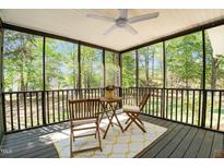 Inviting screened porch with ceiling fan, table and chairs offers tranquil outdoor living space at 720 Raymond Dr, Clayton, NC 27527