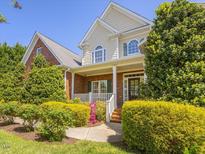 Charming two-story home with a welcoming front porch and lush landscaping at 1008 Maduro Ct, Zebulon, NC 27597
