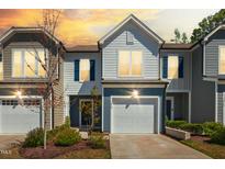 Charming townhome with colorful sunset, a garage, and manicured landscaping enhancing curb appeal at 1020 Sycaten St, Durham, NC 27703