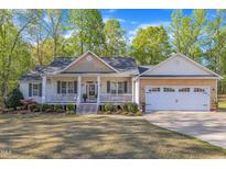 Charming single-story home with a welcoming front porch and well-manicured lawn at 119 Wolf Creek Dr, Wendell, NC 27591