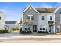 Charming townhome showcases a stone facade and neutral color palette, providing a welcoming curb appeal at 1203 Great Egret Way, Durham, NC 27713