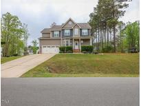 Charming two-story home with an attached two-car garage and landscaped front yard at 198 Shadowbark Dr, Garner, NC 27529