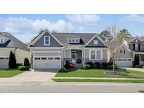 Charming single-Gathering home featuring a landscaped front yard and attached two-car garage at 216 Bella Rose Dr, Chapel Hill, NC 27517