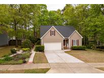 Charming single Gathering home featuring a 1-car garage, landscaped yard, and neutral exterior with red shutters at 216 Harvester Dr, Holly Springs, NC 27540