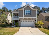 Charming two-story home featuring stone accents, a two-car garage, and a cozy porch at 218 Maple Walk St, Durham, NC 27703
