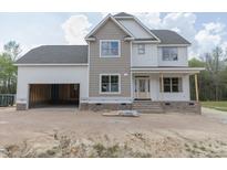 Newly constructed two-story home with a spacious two-car garage and an inviting front porch at 317 Hampshire Court, Four Oaks, NC 27524