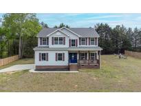 Charming two-story home with covered front porch and well-maintained lawn at 4228 Nc 42 Hwy, Raleigh, NC 27603