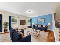 Bright living room features a blue accent wall, plush seating, and a stylish coffee table on a soft rug at 4228 Nc 42 Hwy, Raleigh, NC 27603