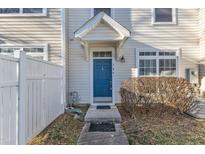 Charming townhouse featuring a blue front door with stylish white trim and covered porch at 5110 Neuse Commons Ln # 109, Raleigh, NC 27616