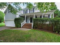 Charming home with a cozy front porch, well-maintained lawn and brick stairway at 704 Voyager Pl, Durham, NC 27712