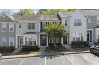 Charming townhome featuring a well-maintained facade with ample parking at 7613 Satinwing Ln, Raleigh, NC 27617
