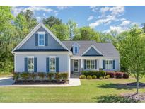 Charming one-story home with blue shutters and a well-manicured lawn at 1101 Sky Wave Trl, Raleigh, NC 27603