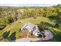 Stunning aerial view of a well-maintained property with lush landscaping, offering a serene and private setting at 1601 Dairyland Rd, Chapel Hill, NC 27516