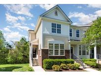 Charming two-story townhome with manicured landscaping and inviting entrance, showcasing the home's curb appeal at 162 Grey Elm Trl, Durham, NC 27713