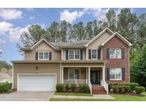 Charming two-story home with a combination of brick and siding and an attached garage at 2 Piney Ridge Ct, Durham, NC 27712