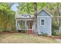 Charming home featuring light blue siding, front porch, and mature trees at 2814 Sarah Ave, Durham, NC 27707