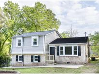 Charming home featuring brick and light gray siding, black shutters, and a well-maintained front yard at 2824 Wyncote Drive, Raleigh, NC 27603
