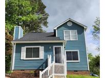 Charming blue two-story home with white trim, inviting entrance, and well-maintained landscaping at 3109 Cinnamon Circle Cir, Raleigh, NC 27610