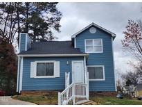 Charming blue two-story home with white trim, shutters, and a well-manicured lawn at 3109 Cinnamon Circle Cir, Raleigh, NC 27610