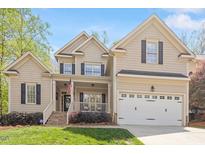 Charming two-story home with a welcoming front porch and manicured landscaping at 317 Okamato St, Raleigh, NC 27603