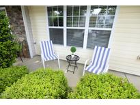 Inviting front porch with striped chairs and garden view at 3623 Bison Hill Ln, Raleigh, NC 27604