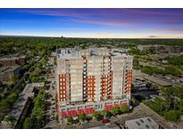 Modern luxury condo building with city views and mature trees at 400 W North St # 502, Raleigh, NC 27603