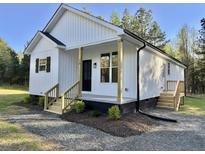 Charming single Gathering home featuring board and batten siding and a welcoming front porch at 50 Lakewood Dr, Roxboro, NC 27573