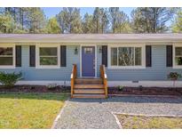 Charming single-story home with light blue siding, black shutters, and a neatly landscaped front yard at 5604 Bobcat Rd, Chapel Hill, NC 27516