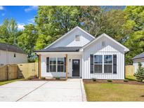 Charming new construction home with white siding, black shutters, and well-manicured lawn at 617 Ray St, Selma, NC 27576