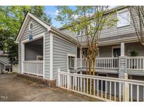 Condo building exterior featuring wood siding and a white railing at 708 Martin Luther King Jr. Blvd # E2, Chapel Hill, NC 27514