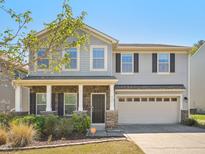Charming two-story home with a welcoming front porch, stone accents, and a two-car garage at 835 Poplar St, Durham, NC 27703