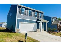 Beautiful two-story home featuring a two-car garage, covered entry, and well-maintained lawn at 107 Gabriel Ct, Wilson's Mills, NC 27520