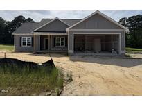 Charming single-story home with a two-car garage, covered porch, and neutral color palette, in a beautiful neighborhood at 107 Tee Dr, Selma, NC 27576