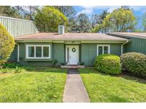 Charming one-story home with a well-manicured lawn and beautiful green exterior at 12 Poppy Trl, Durham, NC 27713