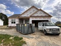 New home construction shows the exterior with a dumpster and contractors van outside at 152 Royal Ave, Selma, NC 27576