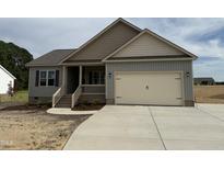 Charming single-story home featuring a two-car garage and inviting front porch at 152 Royal Ave, Selma, NC 27576