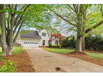 Charming two-story home with an attached garage and mature trees at 1604 Cane Creek Dr, Garner, NC 27529