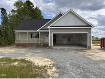 Charming new construction home featuring a two-car garage and covered front porch at 192 Royal Ave, Selma, NC 27576