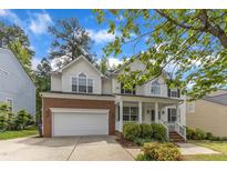 Charming two-story home with a brick-accented garage and landscaped front yard at 2002 Patapsco Dr, Apex, NC 27523