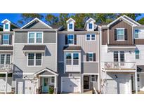 Charming townhome exterior featuring neutral siding, well-maintained landscaping, and inviting curb appeal at 221 Pond View Ct # 9, Fuquay Varina, NC 27526