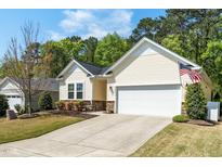 Charming single Gathering home with manicured lawn, 2-car garage, and tasteful landscaping at 3029 Willow Ranch Dr, Fuquay Varina, NC 27526